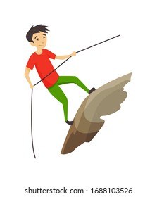 Boy climbing on a rock mountain with equipment