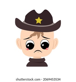 Boy with crying and tears emotion, sad face, depressive eyes in sheriff hat with yellow star. Head of cute child with melancholy expression in carnival costume for the holiday