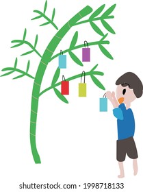 Ein Junge, der einen Streifen Bambusgras in Tanabata schmückt