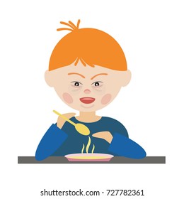 Boy with Down syndrome sitting at a table, holding a spoon independently and is eating hot soup plates