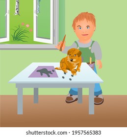 Boy drawing the puppy by placing it on a sheet of paper and drawing lines around it.