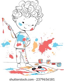 The boy draws. The child is covered in paint.