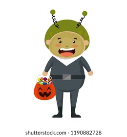 boy dressed up as a halloween martian with candies