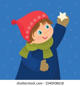 A boy dressed in winter clothes catches a star