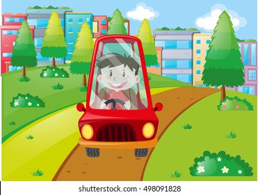 Niño conduciendo un coche rojo en el parque