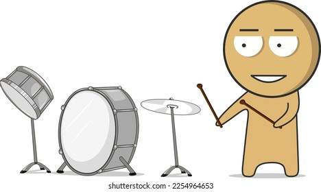 A boy with drumsticks stands next to the drums and smiles  