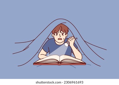 Boy with flashlight reads book lying under covers and is frightened by story described in fictional novel. Frightened boy with book enjoys reading fantasy literature in secret from parents