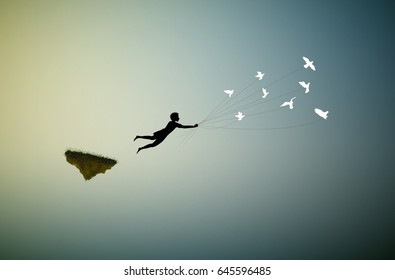 boy  is flying away and holding pigeons, fly in the dream land,fly away, shadows, life on flying rock, silhouette.