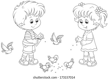 Boy and girl feed birds