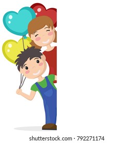 Boy and girl holding balloons in the shape of a heart and look out from behind a white sheet.