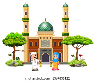 the boy and the girl are holding the Ramadan lantern in front of the green mosque