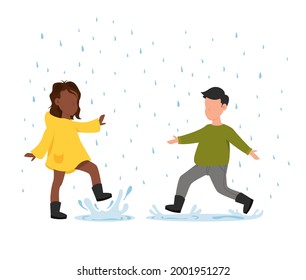 Boy and girl runs in the rain. Autumn fun activities. Children wearing rain boots jumping into a puddle.