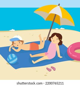 boy and girl sunbathing on a blue rug