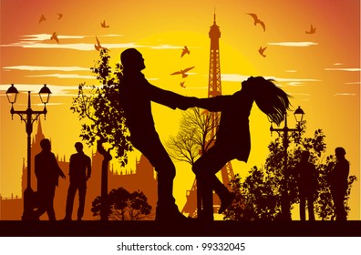 boy and girl swirling in the street in Paris