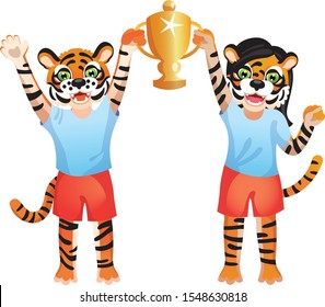 Boy and girl tigers in sport uniform are holding on both sides the gold goblet