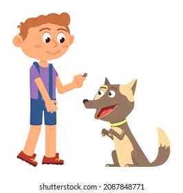 Boy giving treat to puppy. Dog training. Pet feeding