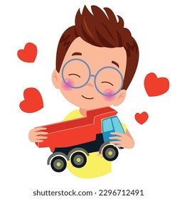 A boy with glasses holding a toy truck with hearts on his chest