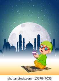 the boy with the glasses are reading al quran in the bright moonlight