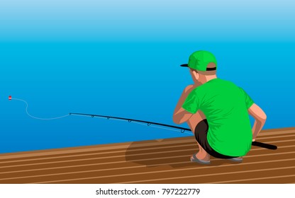 Boy in the green shirt and black shorts is sitting on the dock with a fishing rod. Fishing from the pier into the sea or a river shore