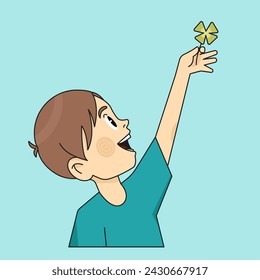 Boy happy holding four leaf good luck clover in hands