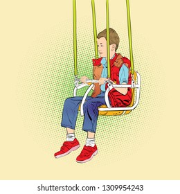 Boy has fun on the rides. Amusement park. Playground. Swinging on swing.
