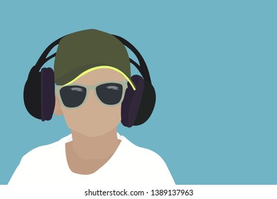 The boy in headphones is wearing a white T-shirt. Top view of a child listening to music with headphones on a green background.