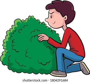 boy hiding behind a bush and watching