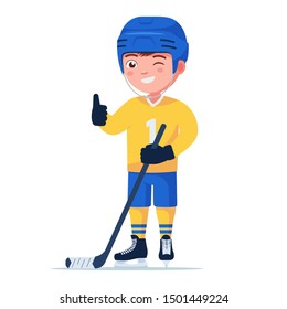 Boy a hockey player in a sports uniform stands with a stick and holds his thumb up. Small child in hockey skates and a helmet holds a club. Vector illustration isolated on white, flat style.