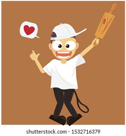 A boy holdind a rolling pin happily.Making bread with his passion for bread.