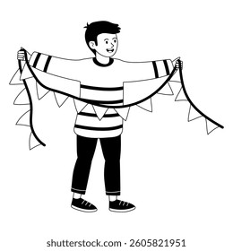Boy holding colorful bunting for celebration at a community event in the park