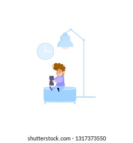 The boy is holding a tablet, on the background of a lamp and a chair
