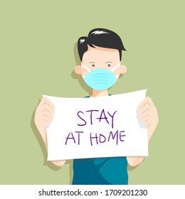 The boy holds a paper that says stay at home