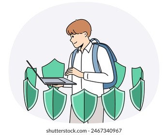 Boy with laptop is learning cyber protect and installing antivirus software standing among green shields. School student uses apps to cyber protect personal data from hackers or viruses