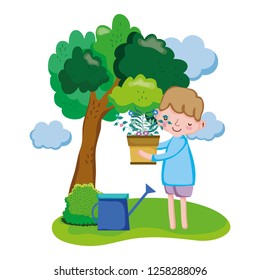 boy lifting houseplant with sprinkler in the landscape
