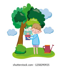 boy lifting houseplant with sprinkler in the landscape