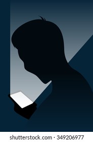 Boy looking at smart phone in the dark