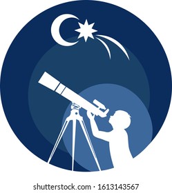 boy looks through a telescope