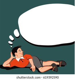 Boy lying on the floor and deep in thought
