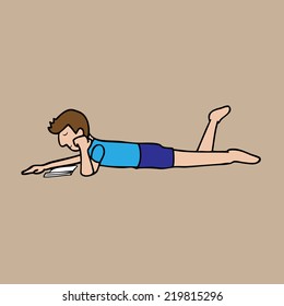 Boy lying and reading on floor