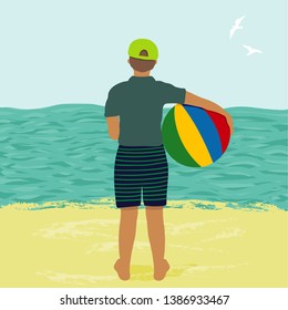Boy on the beach looking at the sea.