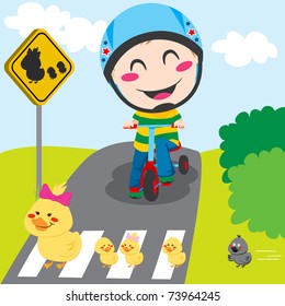 Boy on tricycle waiting in front of a ducks crossing sign