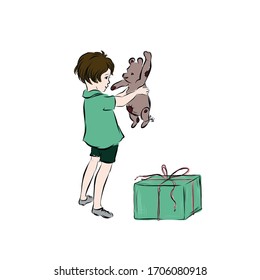 Boy opens gift. Child holds soft toy of bear. Child’s birthday. 