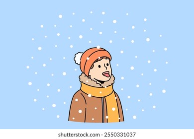 Boy opens mouth and eating snow, enjoying winter weather and new year mood. Christmas portrait of small child in scarf and warm hat, rejoicing with first snow or onset of winter holidays