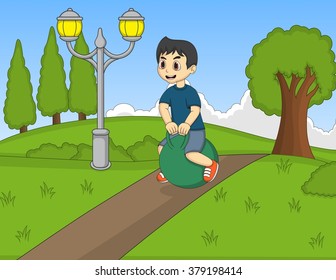 Boy playing bouncing ball in the park