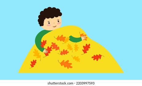boy playing with a bunch of fallen leaves