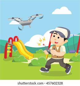boy playing drone in park