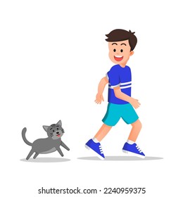 a boy playing with his pet cat