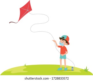 A boy playing kite on the field while using medical mask