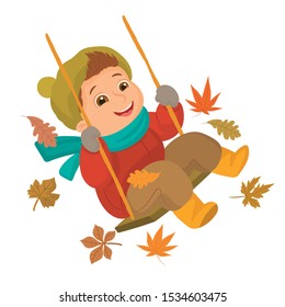 boy playing on swing among autumn leaves