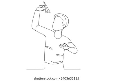 A boy playing paper airplane. Paper plane one-line drawing